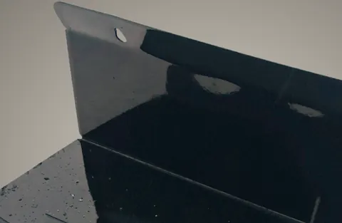 Close-up of the keyhole slot on a gloss black rack.