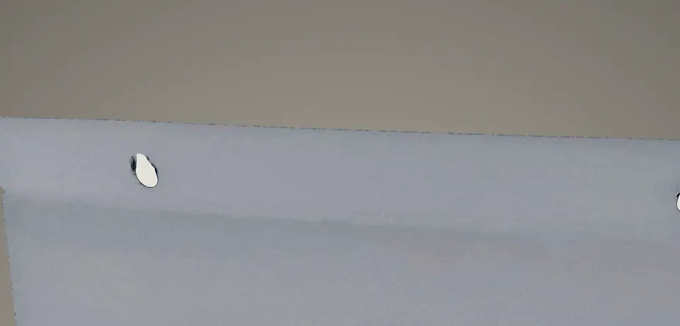 The back panel of a white Triad, with both keyhole slots.